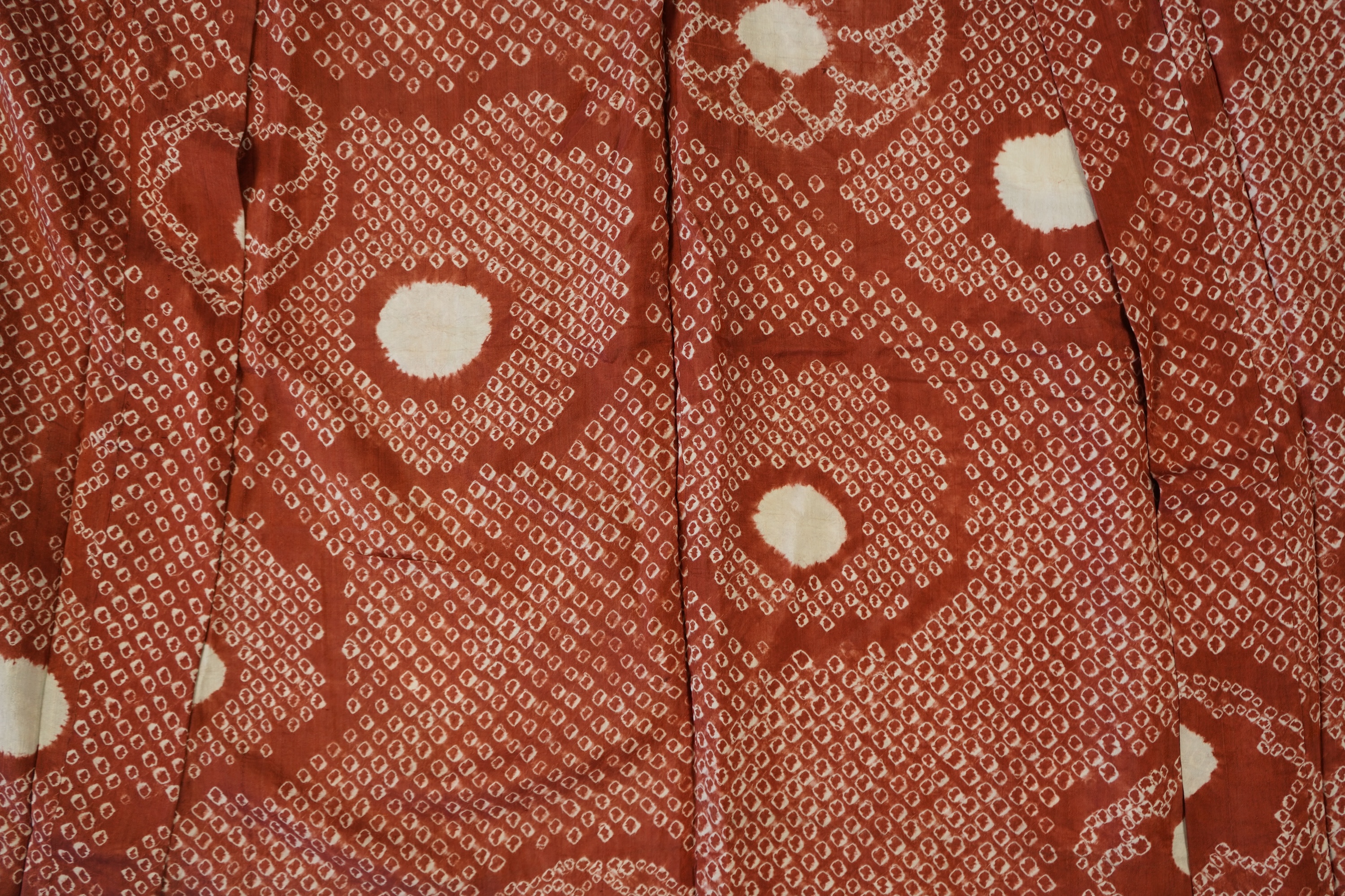 Three Japanese mid 20th century ‘Haori’ printed silk jackets. One red with brightly coloured lining and rust brown floral silk lining. All with large kimono sleeves. Grey patterned Haori, 79cm long., Condition - good